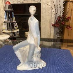 Elegant sitting boy figurine made by Nao in Spain