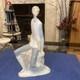 Elegant sitting boy figurine made by Nao in Spain