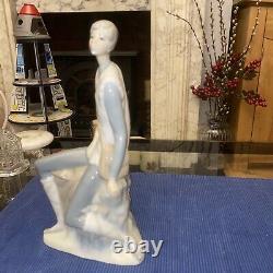 Elegant sitting boy figurine made by Nao in Spain