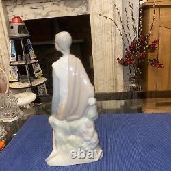 Elegant sitting boy figurine made by Nao in Spain