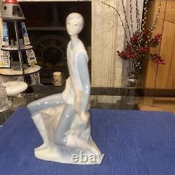 Elegant sitting boy figurine made by Nao in Spain