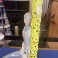 Elegant sitting boy figurine made by Nao in Spain