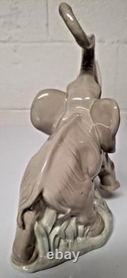 Grey elephant figure. Lladro NAO Spain porcelain, trunk, foot raised. 8.5 high