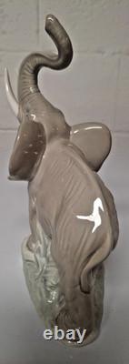 Grey elephant figure. Lladro NAO Spain porcelain, trunk, foot raised. 8.5 high
