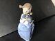 Lladro Nao girl with pigtals holding her puppy. Excellent condition. 7in. Tall