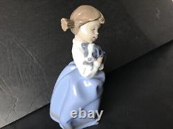 Lladro Nao girl with pigtals holding her puppy. Excellent condition. 7in. Tall