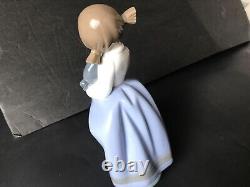 Lladro Nao girl with pigtals holding her puppy. Excellent condition. 7in. Tall