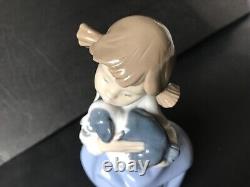 Lladro Nao girl with pigtals holding her puppy. Excellent condition. 7in. Tall