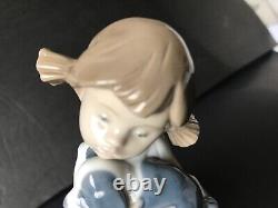 Lladro Nao girl with pigtals holding her puppy. Excellent condition. 7in. Tall