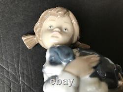 Lladro Nao girl with pigtals holding her puppy. Excellent condition. 7in. Tall