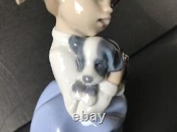 Lladro Nao girl with pigtals holding her puppy. Excellent condition. 7in. Tall