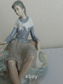 NAO by Lladro Figurine Girl Resting on a Log with a Hat