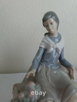 NAO by Lladro Figurine Girl Resting on a Log with a Hat