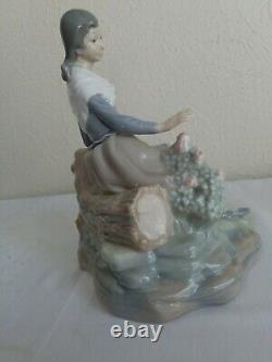 NAO by Lladro Figurine Girl Resting on a Log with a Hat