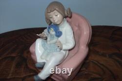 Nao By Lladro 15 CM Pig Tail Girl Sitting In A Pink Armchair Playing With A Doll
