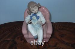Nao By Lladro 15 CM Pig Tail Girl Sitting In A Pink Armchair Playing With A Doll