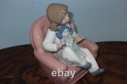Nao By Lladro 15 CM Pig Tail Girl Sitting In A Pink Armchair Playing With A Doll