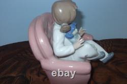 Nao By Lladro 15 CM Pig Tail Girl Sitting In A Pink Armchair Playing With A Doll