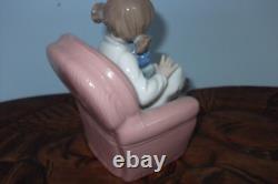 Nao By Lladro 15 CM Pig Tail Girl Sitting In A Pink Armchair Playing With A Doll