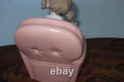 Nao By Lladro 15 CM Pig Tail Girl Sitting In A Pink Armchair Playing With A Doll