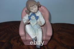 Nao By Lladro 15 CM Pig Tail Girl Sitting In A Pink Armchair Playing With A Doll