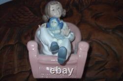 Nao By Lladro 15 CM Pig Tail Girl Sitting In A Pink Armchair Playing With A Doll