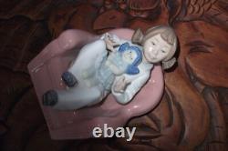 Nao By Lladro 15 CM Pig Tail Girl Sitting In A Pink Armchair Playing With A Doll